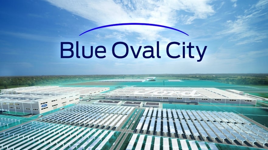 Blue Oval City (the name of Ford's Battery park) logo in a clear sky over a field of batteries.
