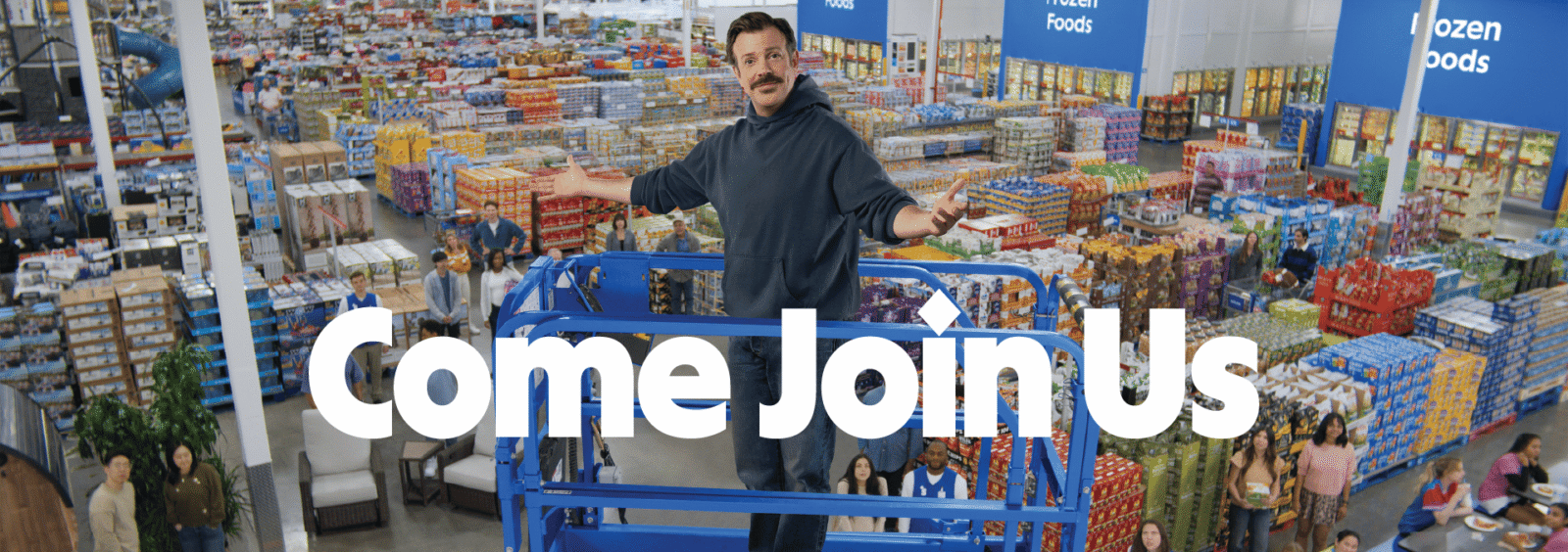 Man on a blue lift in a crowded Sam's Club, arms extended as if inviting; large 'Come Join Us' text overlays the scene.